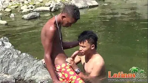 Teen gay swimmer playfully going down in the river Klip teratas besar