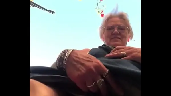Big Grandma shows big slit outside top Clips